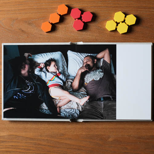 Photo book showing family relaxing in bed