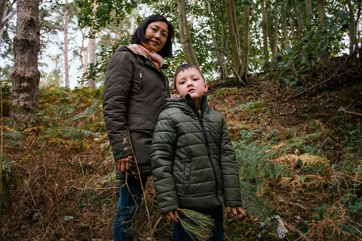 Portrait of mother and boy in forest.