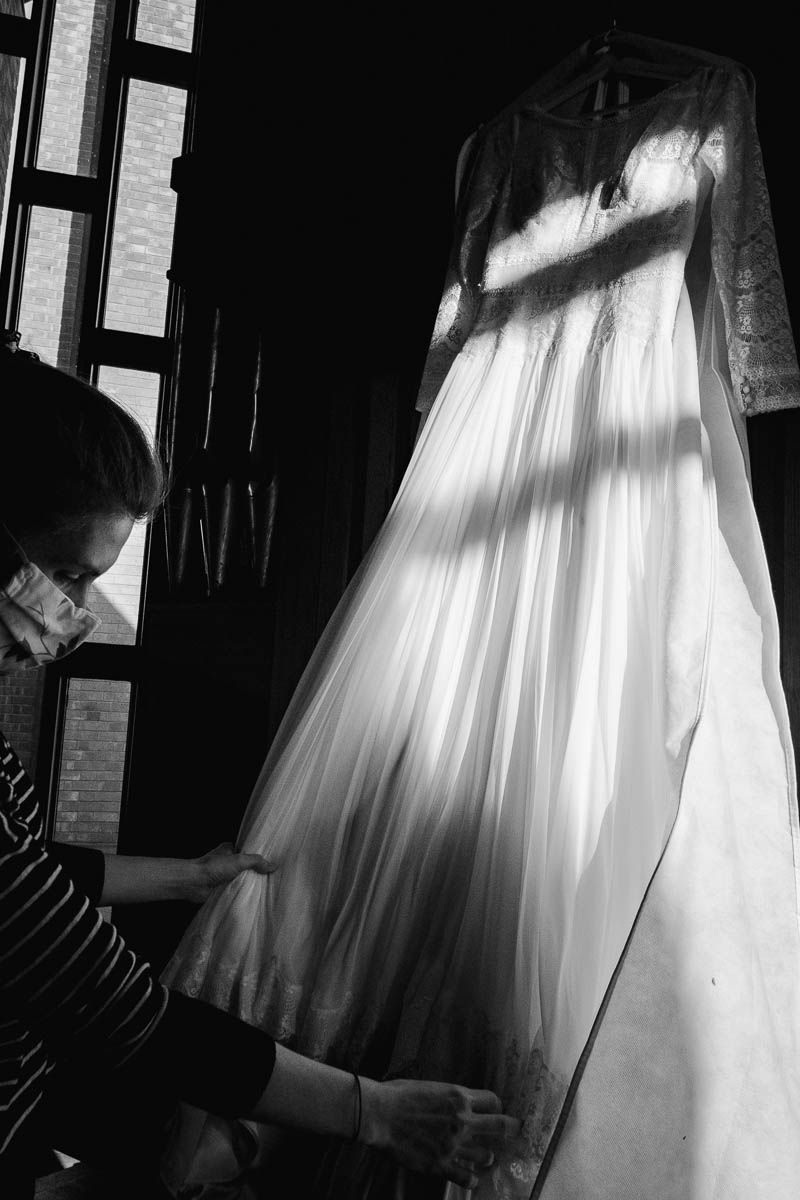 woman straightening wedding dress