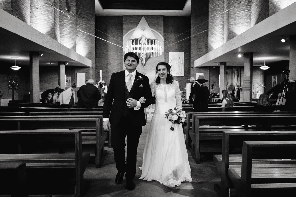 Bride and groom walk out of church together