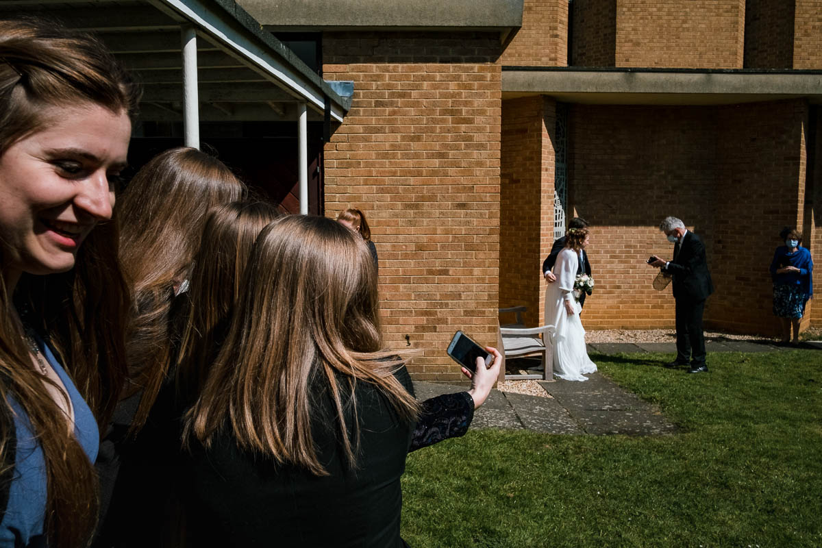 Wedding guests take group selfie after ceremony