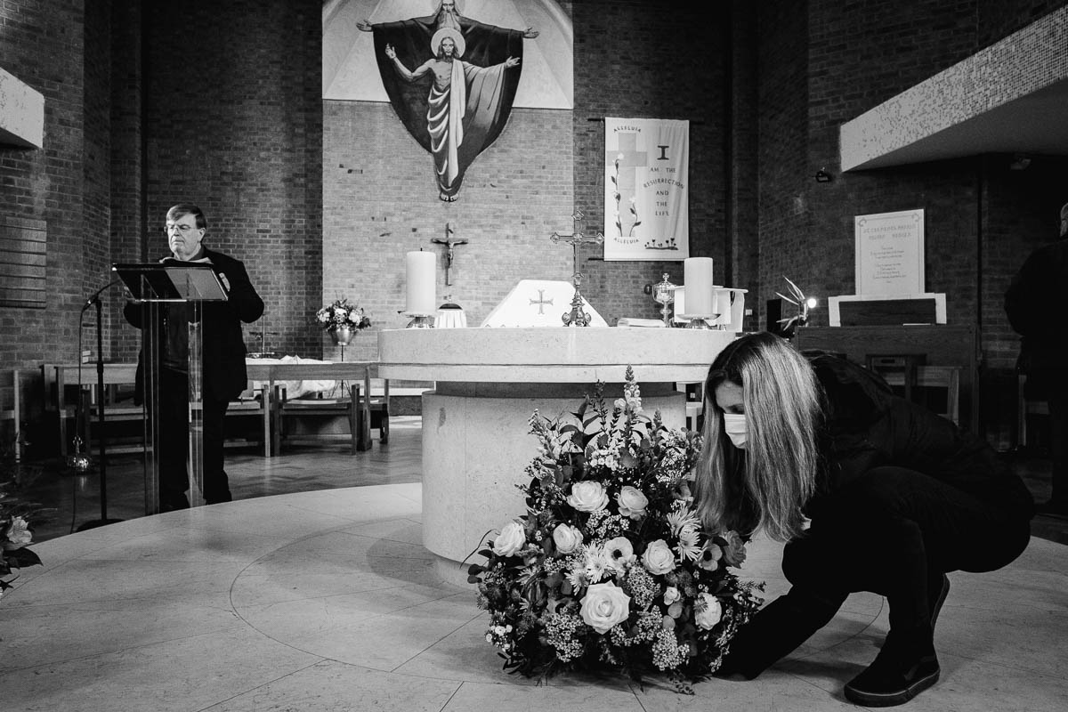 Lady laying floral display in church before wedding